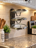 Three tier cooking lid holder that holds cooking lids upside down to prevent spillage of condensation on your counters and also frees up counterspace for meal prep. Very handy to have one on each side of your stove. They hold all shapes and sizes of lids, platters & cookie sheets. They can also be mounted inside cabinets to organize your cooking lids. (Black option shown here)