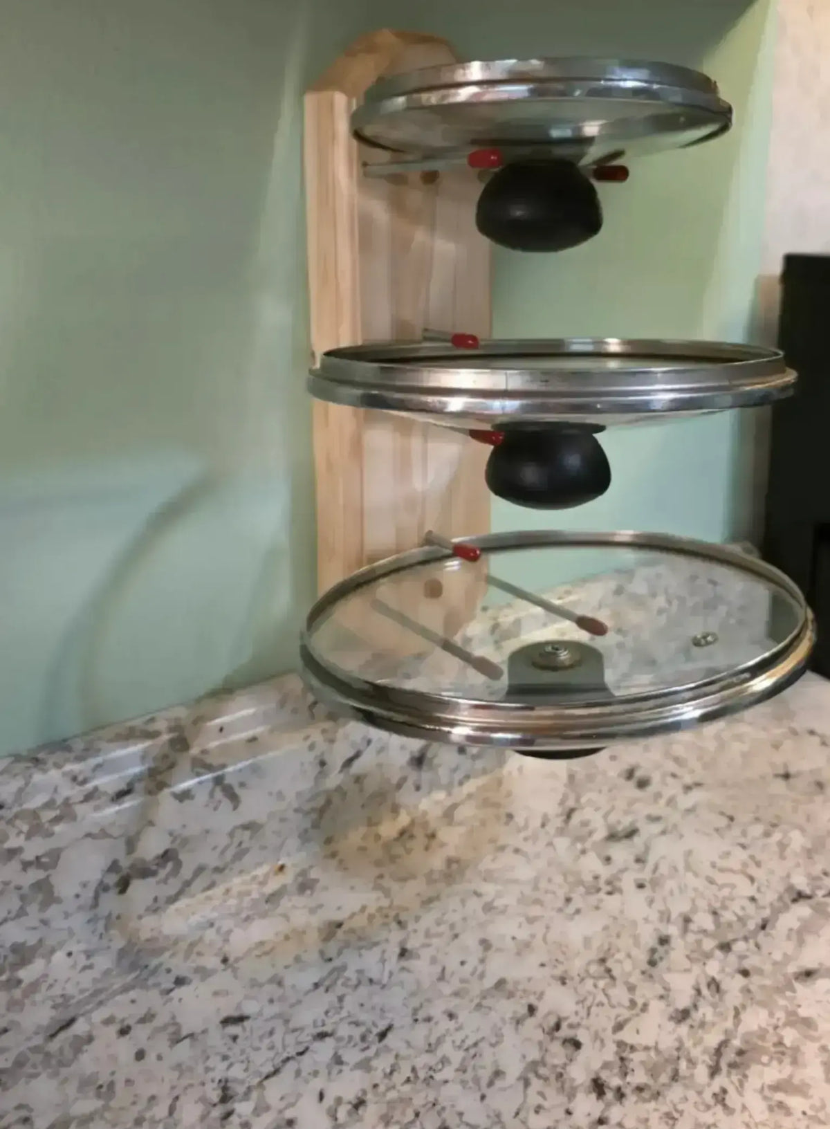 Three tier cooking lid holder that holds cooking lids upside down to prevent spillage of condensation on your counters and also frees up counterspace for meal prep. Very handy to have one on each side of your stove. They hold all shapes and sizes of lids, platters & cookie sheets. They can also be mounted inside cabinets to organize your cooking lids. (Natural Wood option shown here)